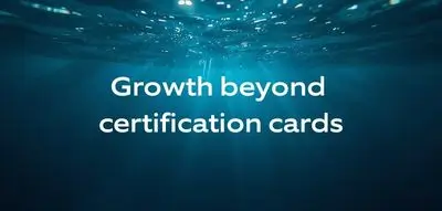 Calm underwater background illustrating professional growth beyond certification cards in diving.