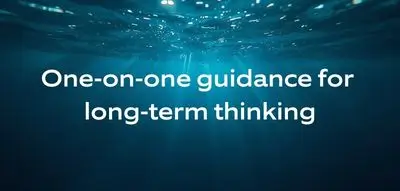 Soft underwater light representing personal, one-on-one mentorship for long-term professional growth in diving.
