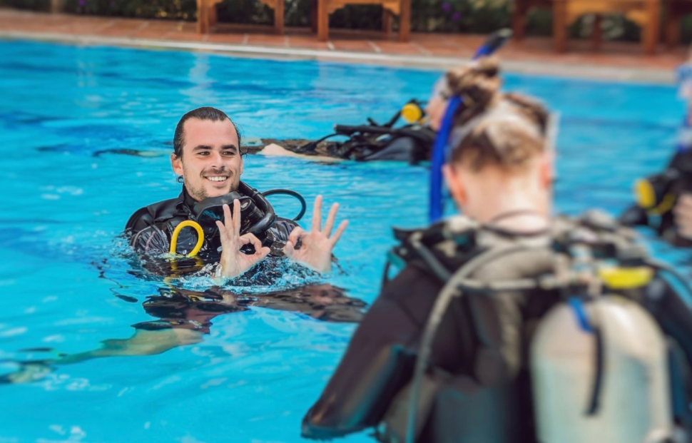 PADI instructor conducting training in a pool, illustrating the benefits of becoming PADI instructor after divemaster.
