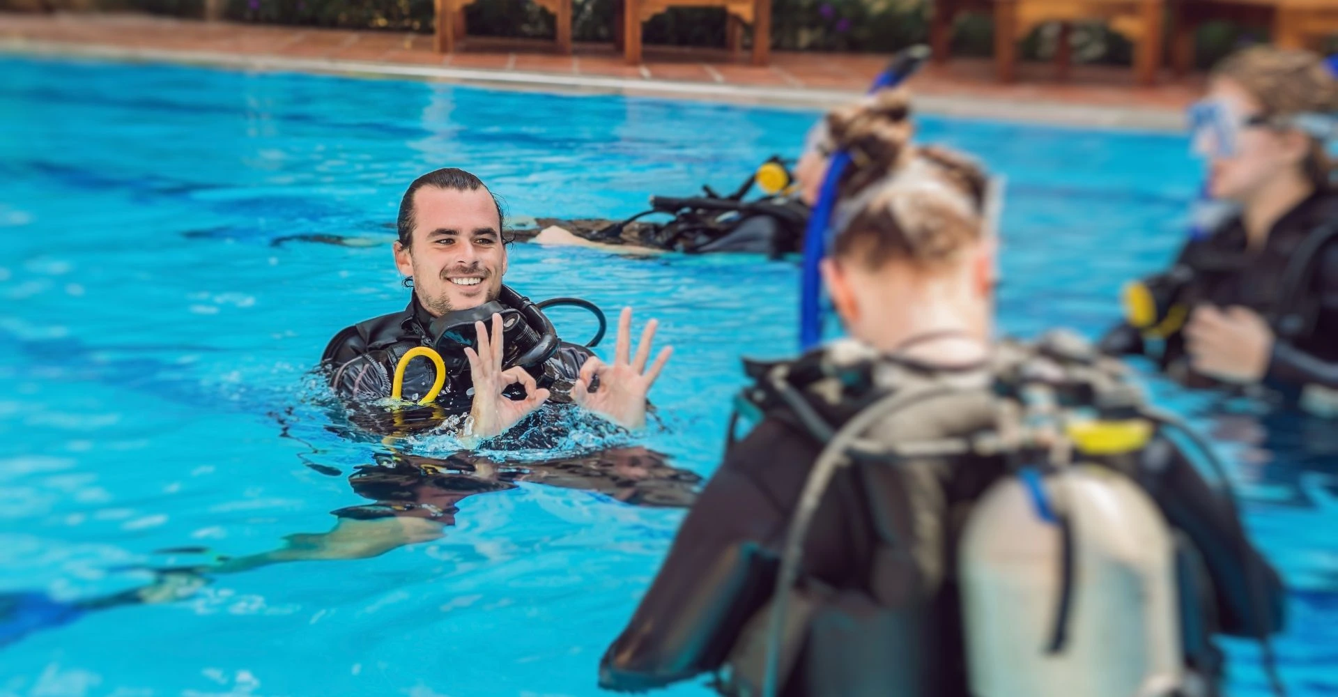 PADI instructor conducting training in a pool, illustrating the benefits of becoming PADI instructor after divemaster.