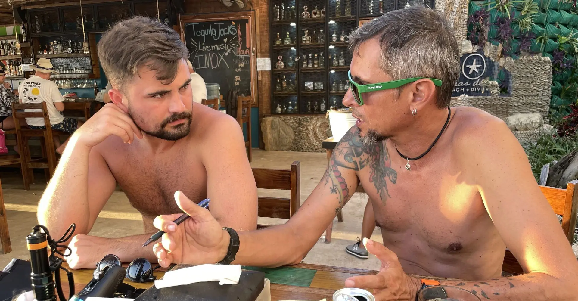Course Director debriefing with an IDC candidate, showing the personal mentorship that comes with choosing a course director who supports your growth.