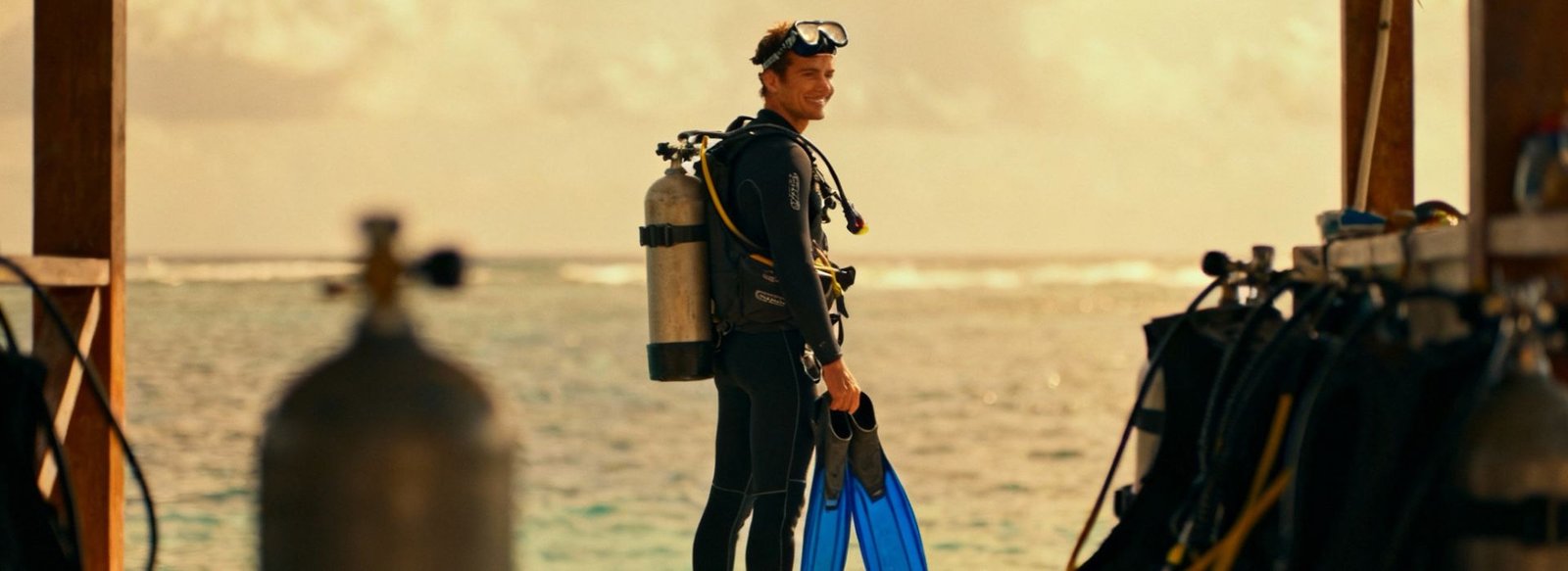 PADI instructor in full gear on a dock, representing how PADI membership benefits support a real diving career.