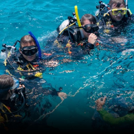 Divemaster course training led by an experienced instructor guiding candidates during a real dive operation