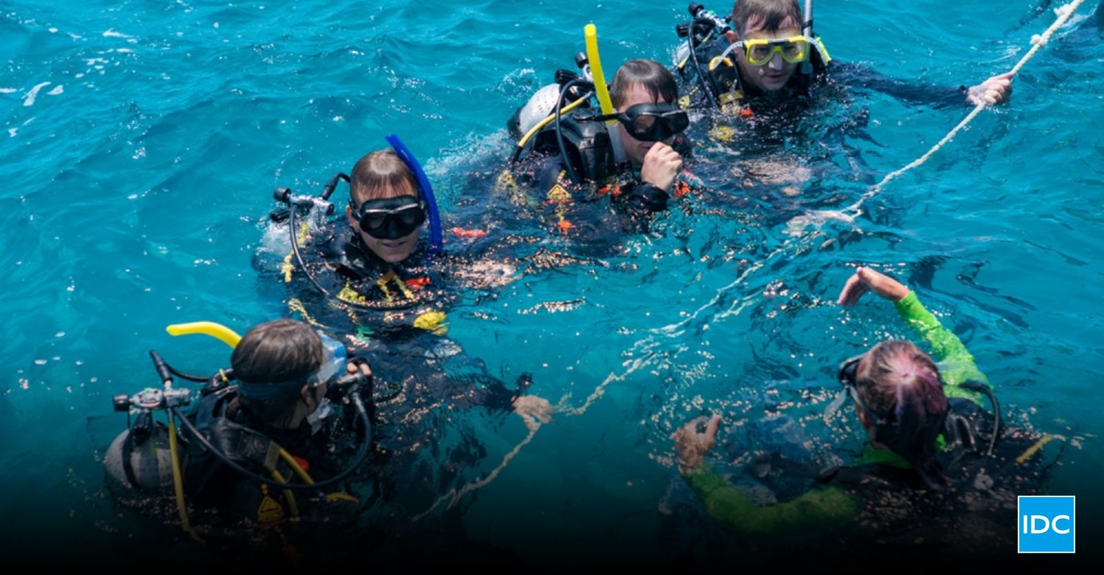 Divemaster course training led by an experienced instructor guiding candidates during a real dive operation