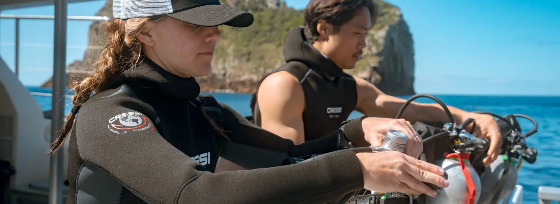 Dive instructor skills on a dive boat, preparing gear and checking equipment before a dive