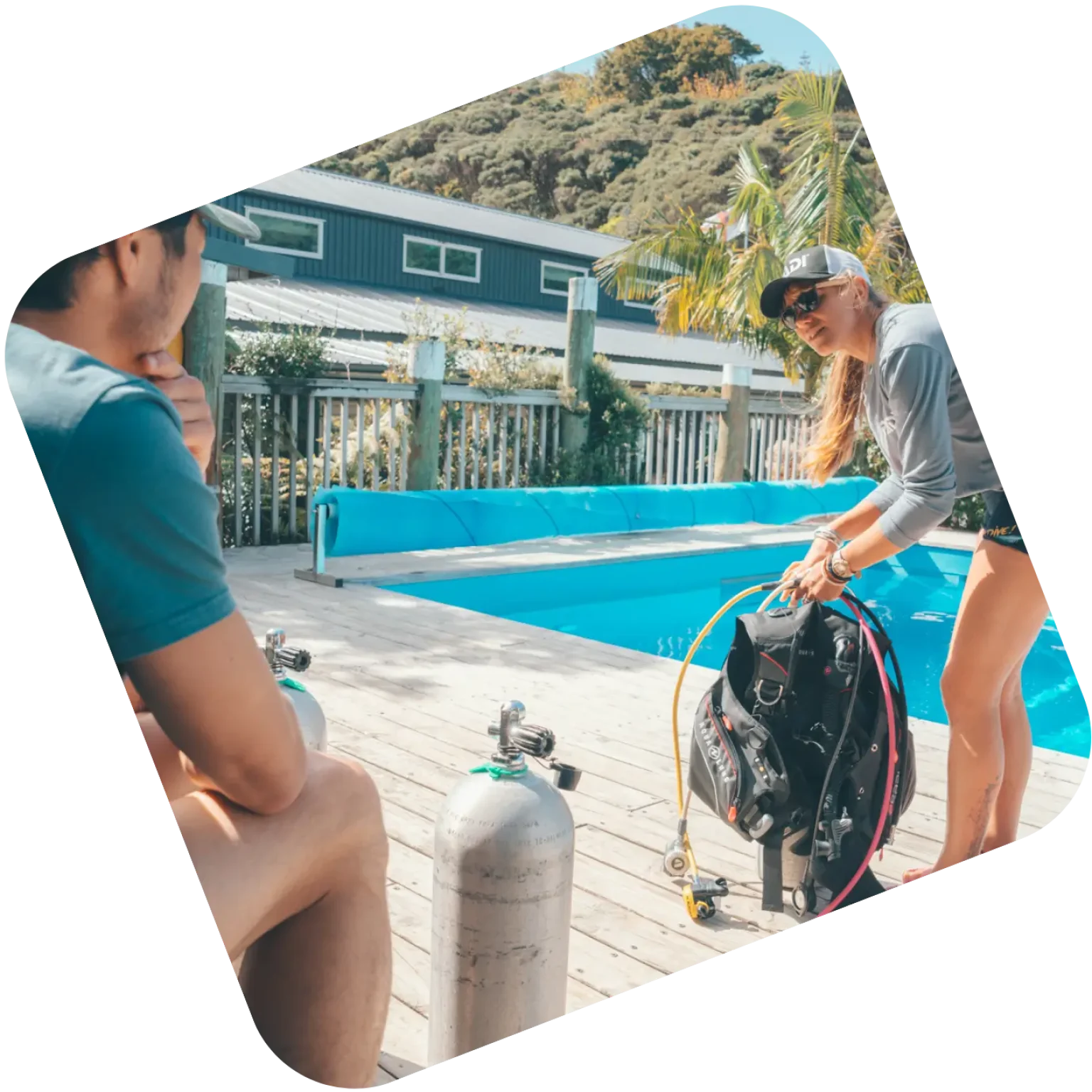 PADI instructor course in Roatan training session with dive gear briefing beside a pool