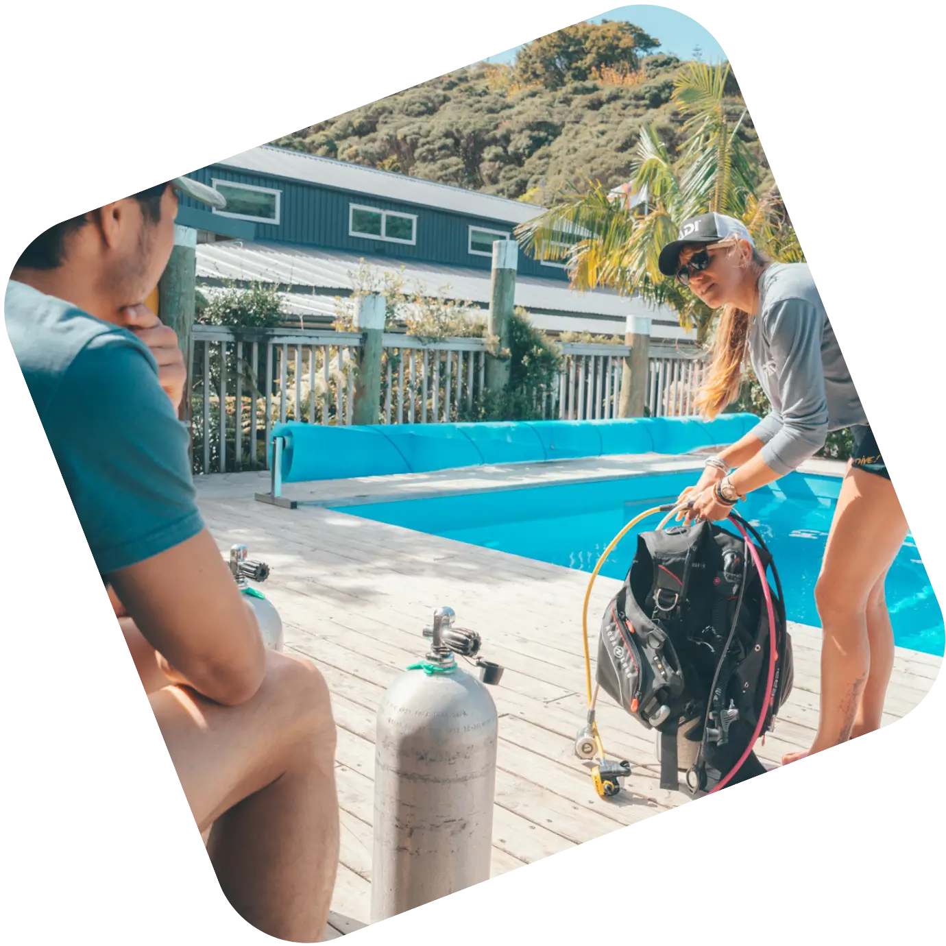 PADI instructor course in Roatan training session with dive gear briefing beside a pool